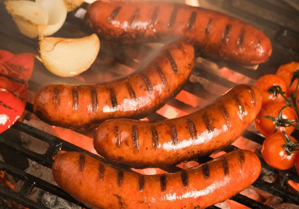 Barbecue with sausages and charred vegetables